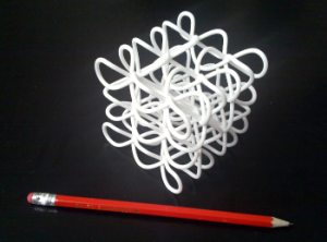 The physical printed 3D knot next to a pencil